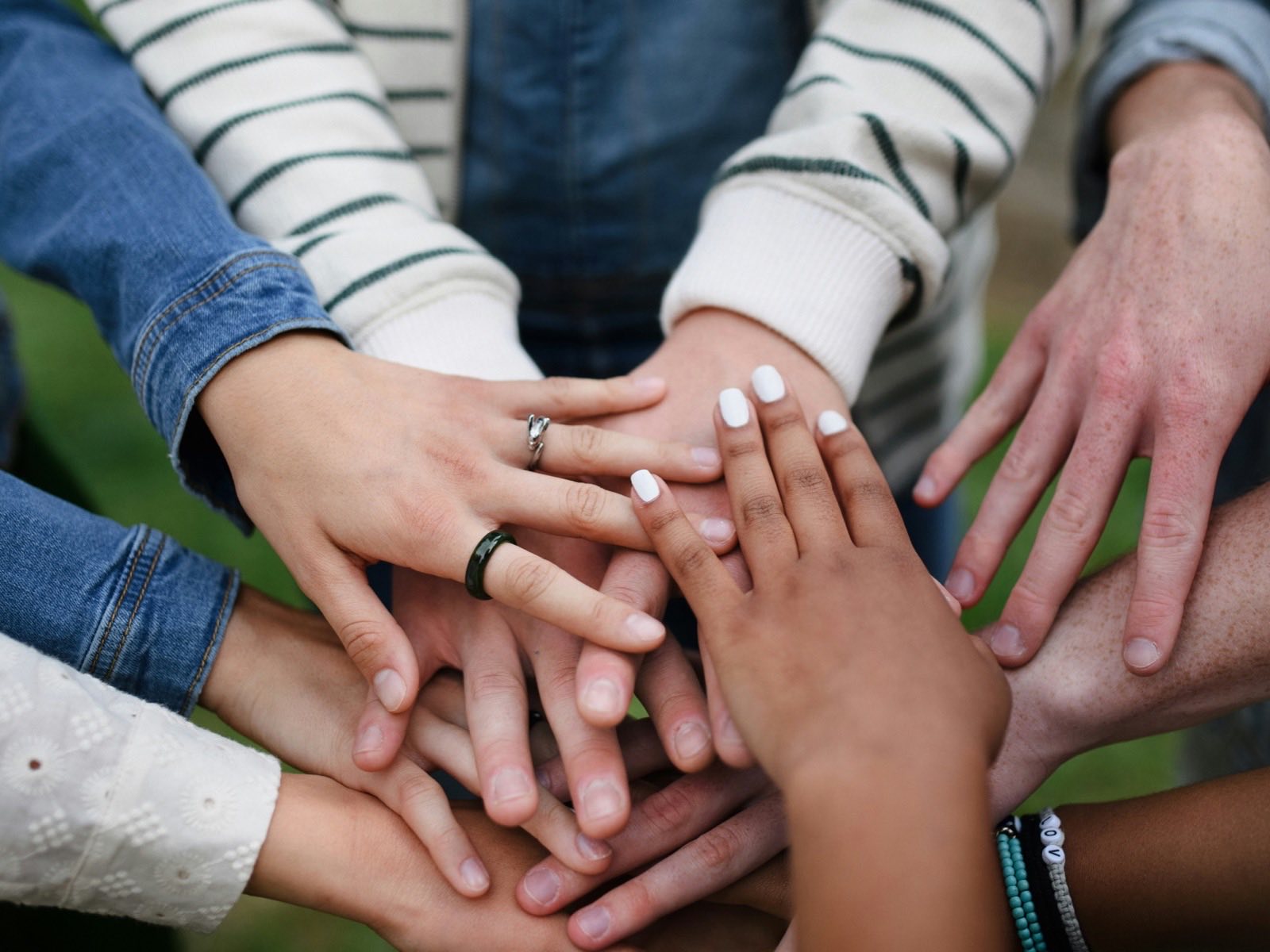 A diverse group of hands stacked together in a circle